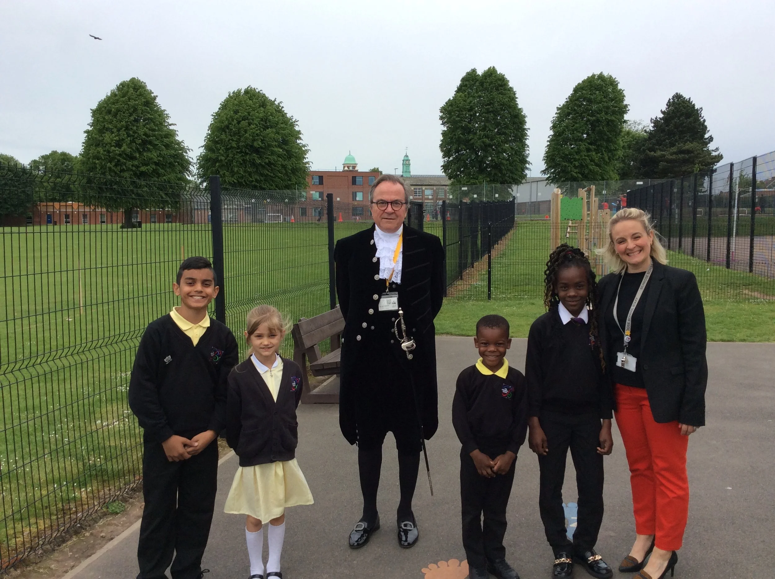 a photo of the High Sheriff and head of primary Kate Beecroft with a group of children.