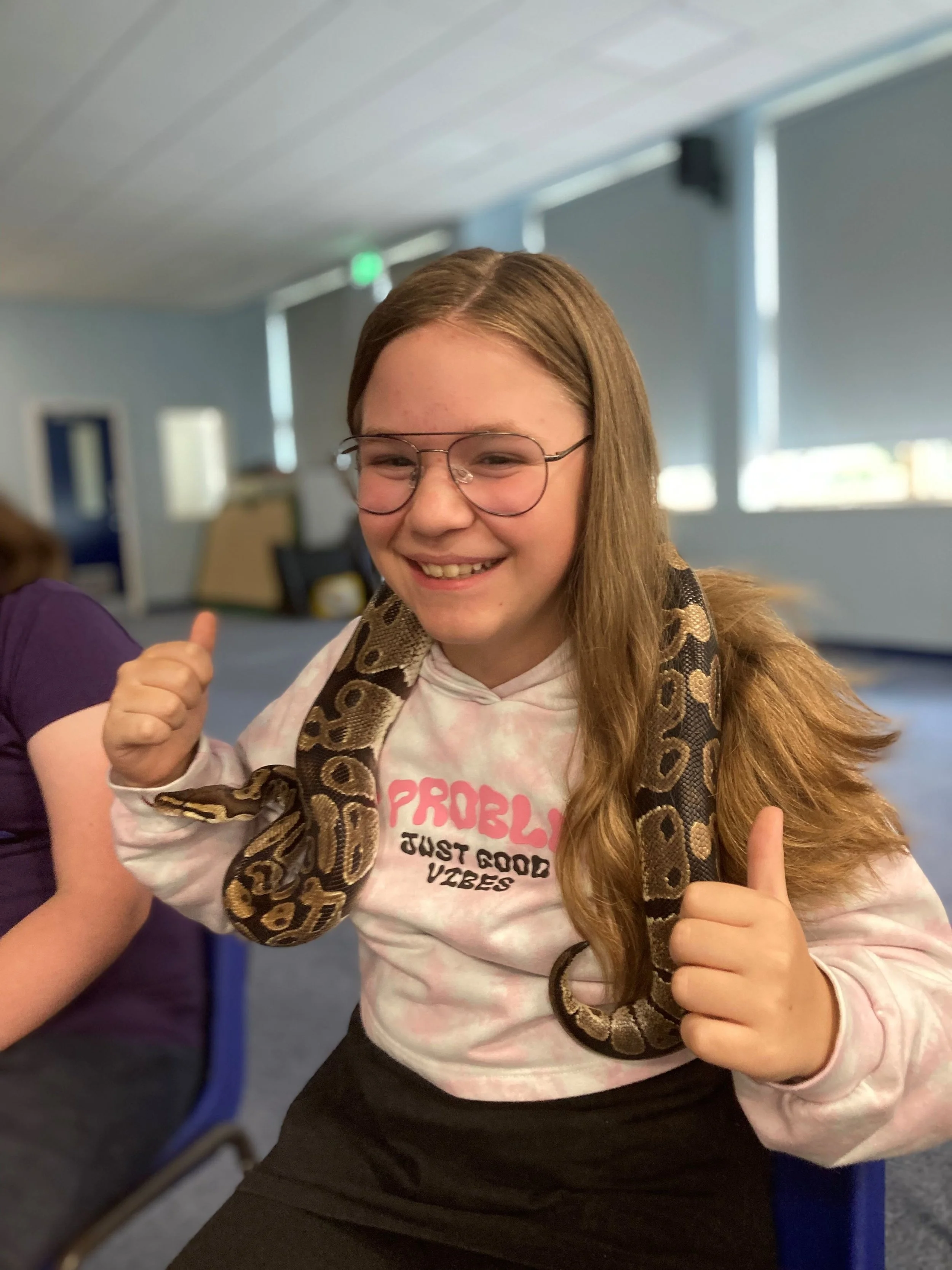 Millie Cox enjoys wearing Chunk, a Royal Python snake, around her neck