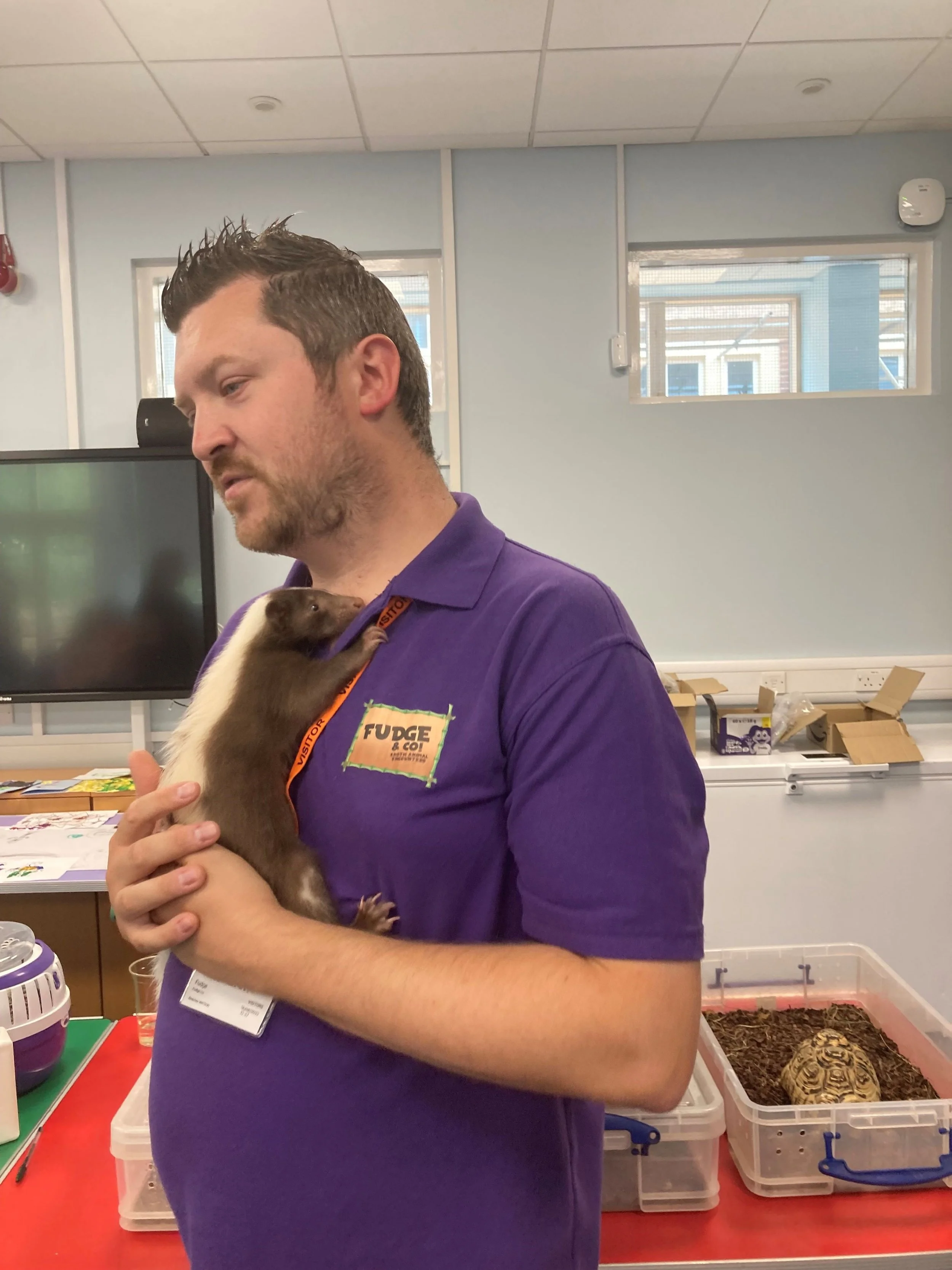 Dan Sleight, co-owner of Fudge & Co Exotic Animal Encounters, holding Bindy, a blue-tongued skink;