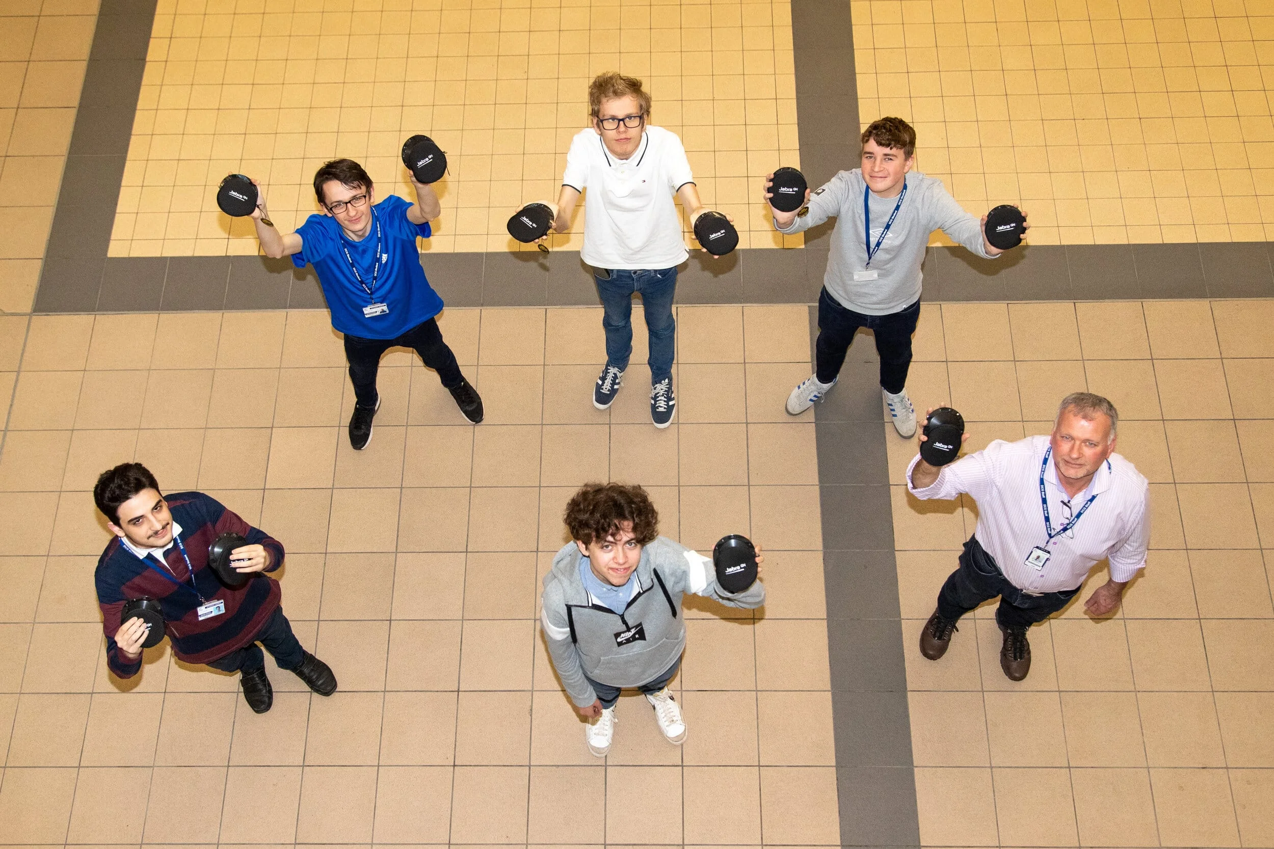 Derby College digital science T-Level students with teacher Mark Shore (right) show off the 10 Jabra Pucks that have been donated by Hazelwood firm Lubrizol.