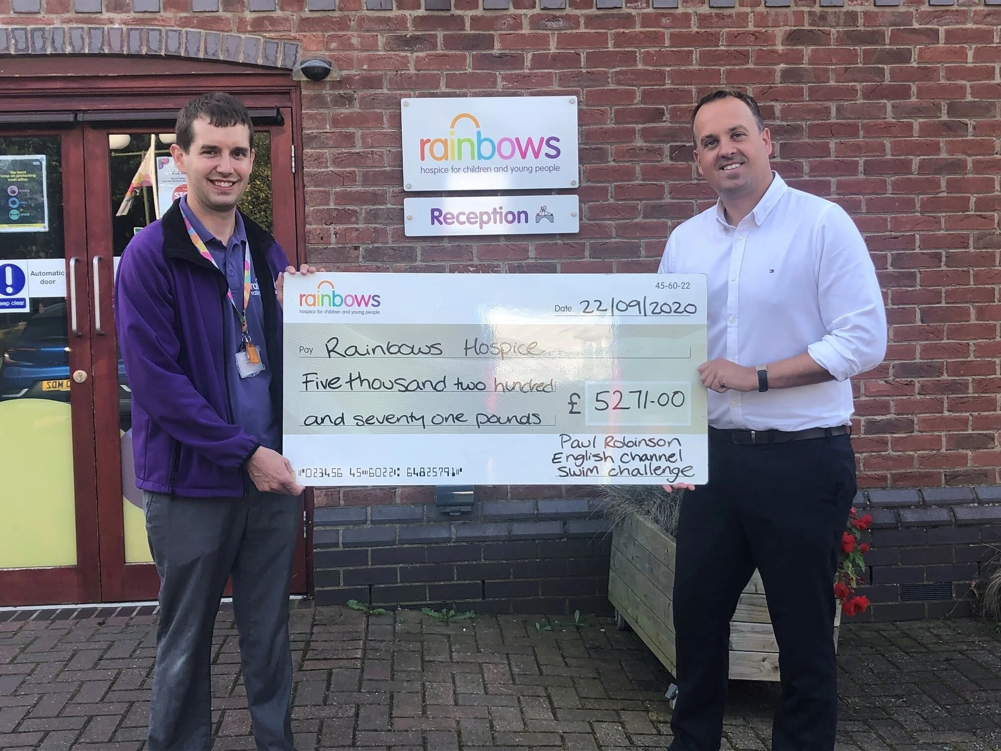 Paul presents a cheque to Rainsbows Hospice