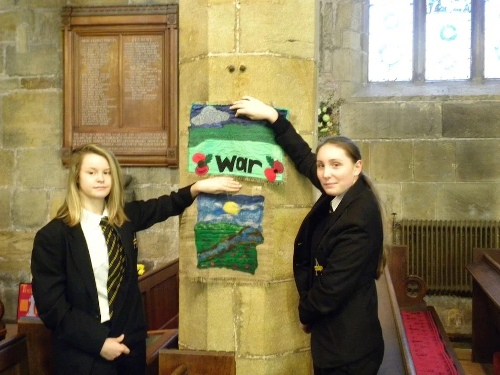 Swinton Academy students Freya Bull and Jess Banks with one of the tapestries presented to St Nicholas' Church as part of their Poppy Memorial Trail to mark 100 years since the end of the First World War. Penguin PR: Public relations, media and comm…