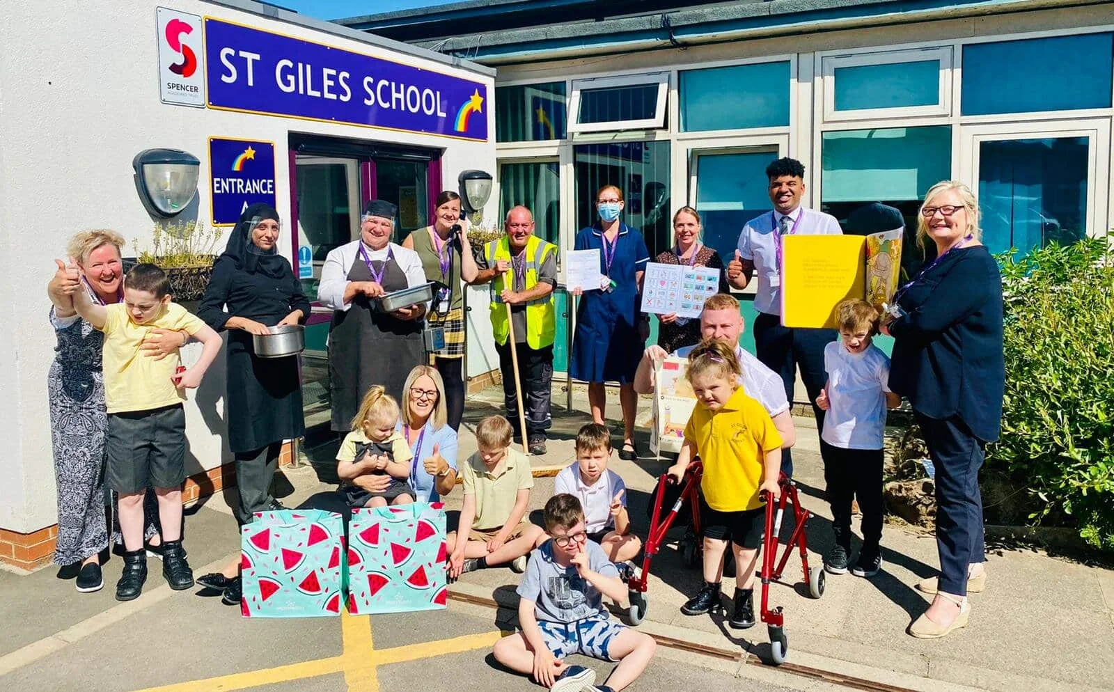 They’re beacons! St Giles School pupils, caretaker, cleaning staff, catering staff, cook, communication practitioner,  admin, teaching staff, teaching assistants, family support practitioner and executive head teacher, Clive Lawrence.