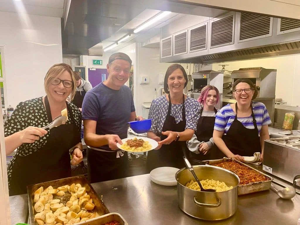 Penguin PR team serving up their meal at the YMCA