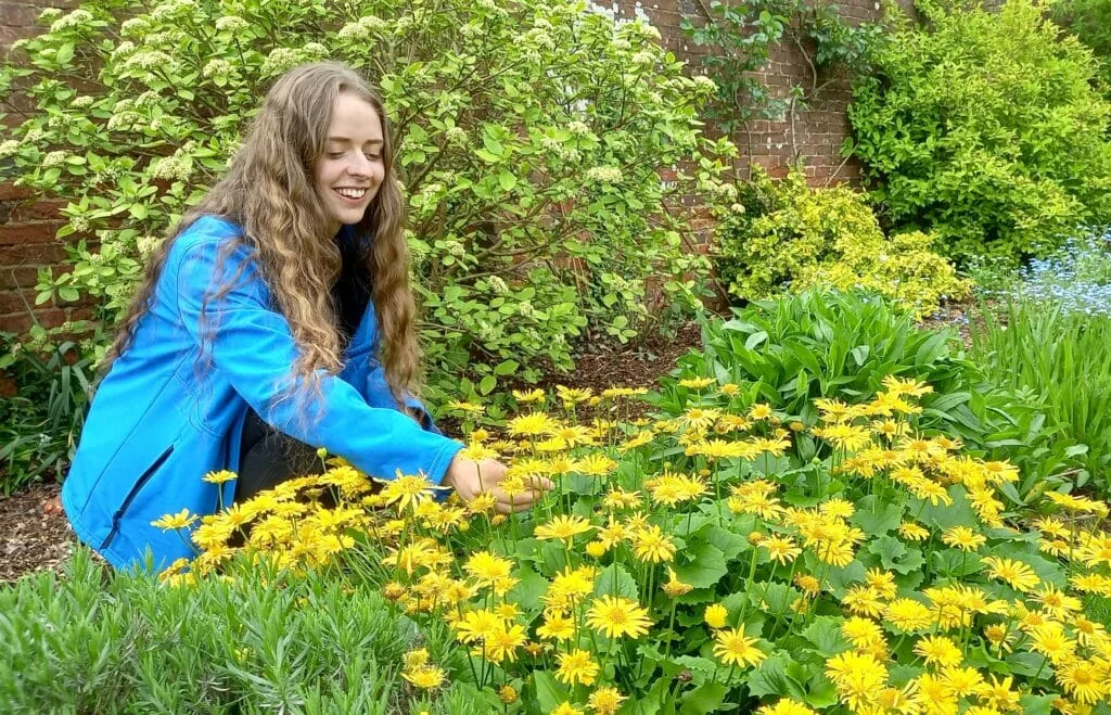 Chelsea Warner from SureScreen Scientifics looking at her flowers