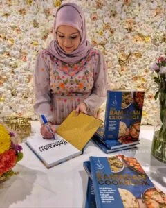 Food blogger Anisa Karolia signing her Ramadan Cookbook