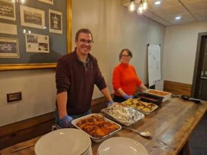 Tom Grazier and Rachel Ollier serving hot meals with Derby County Community Trust