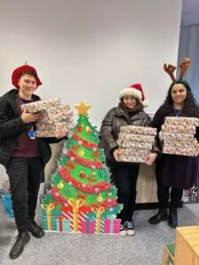 Lauren Dimmock, Sinead Quinn and Faiza Mahmood with Project Youth Cancer boxes