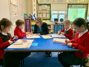 Head teacher Teresa Bosley with Cora Weller, 8, Tate Hilton, 8, Isabella Housley Bates, 7, and Cecily Stafford Northcote, 8, of Marston Montgomery Primary School