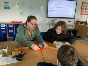 Teacher doing practical lessons with students at Fountains High School