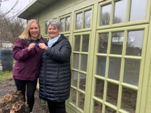 Nikki Webster, of Bridge the Gap, receiving the keys from Sallyann Smith, of Roundpeg