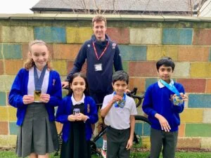 Triathlete Hugo Milner with pupils of St Peter's School