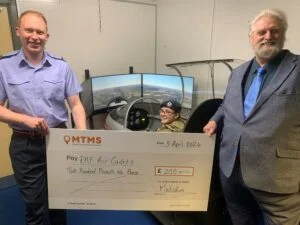 Air cadets in Swadlincote holding a cheque with rail firm MTMS group chairman Malcolm Prentice