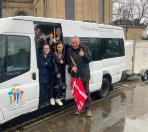 Children leaving from the Bonnie Prince statue in Derby for the first of this year’s Derbyshire Children’s Holiday Centre breaks in March, 2024, with charity chairman Alan Grimadell