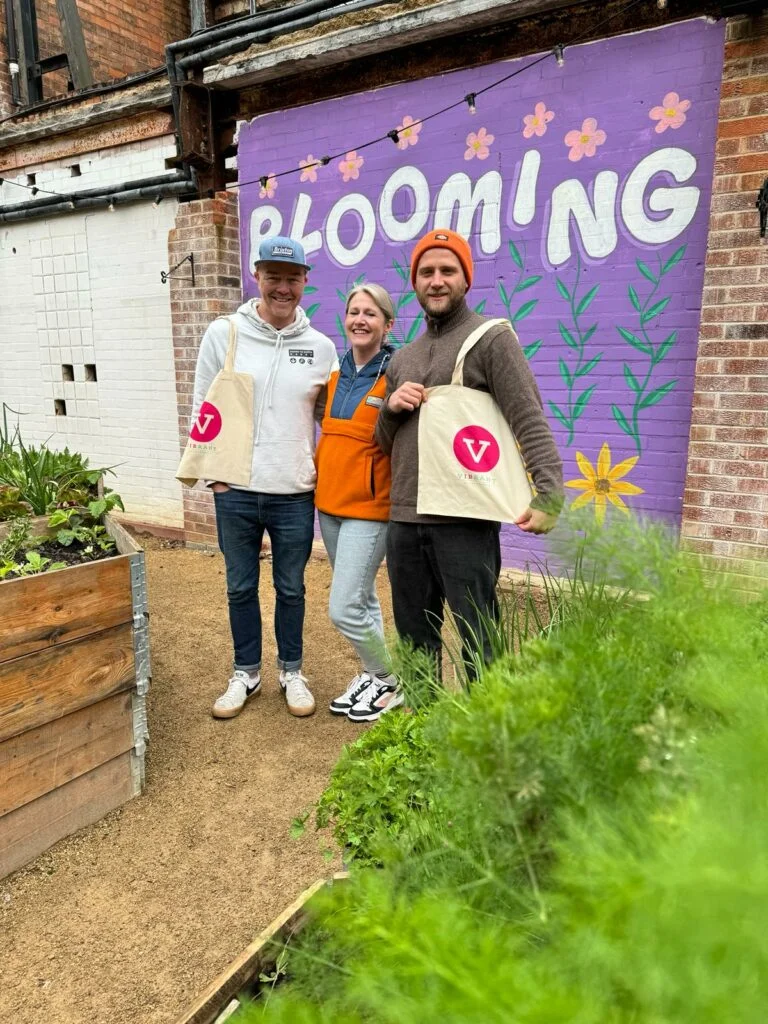 Down To Earth founders Ross Nicholson and Jamie Quince-Starkey post with Vibrant Accountancy's Bev Wakefield at a very bright and colourful Electric Daisy