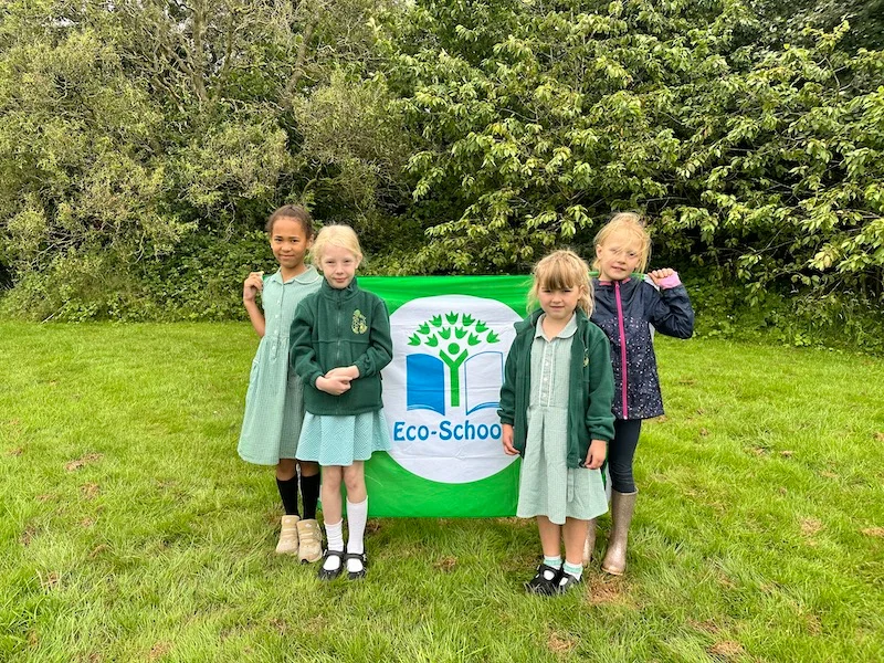 Image shows L-R, Eco Council Members Ava-Maria, Ava Whatley, Connie Partridge, Emily Roome, with the Green Flag.