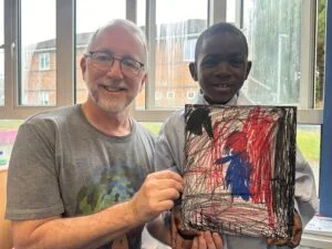 Stephen Iliffe with pupil Emmanuel Ojoarowho wants to be a spaced doctor when hes older