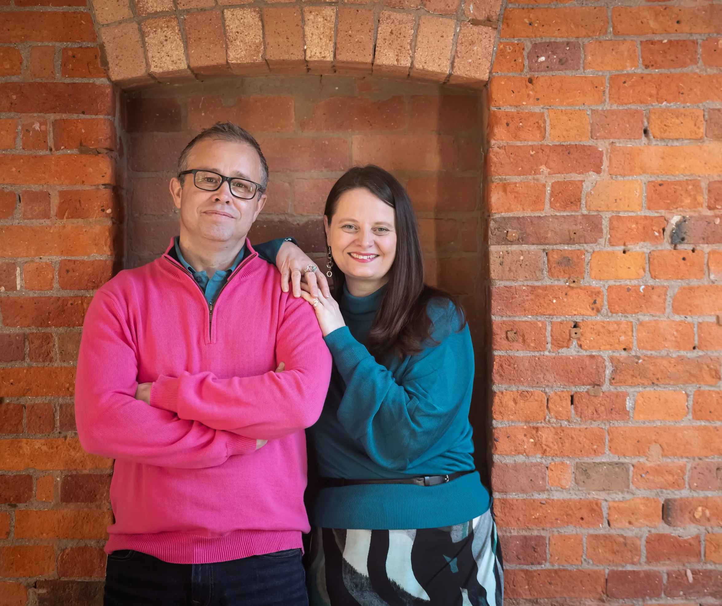 picture of Q Branch founders Matt and Jenny in front of a brick wall