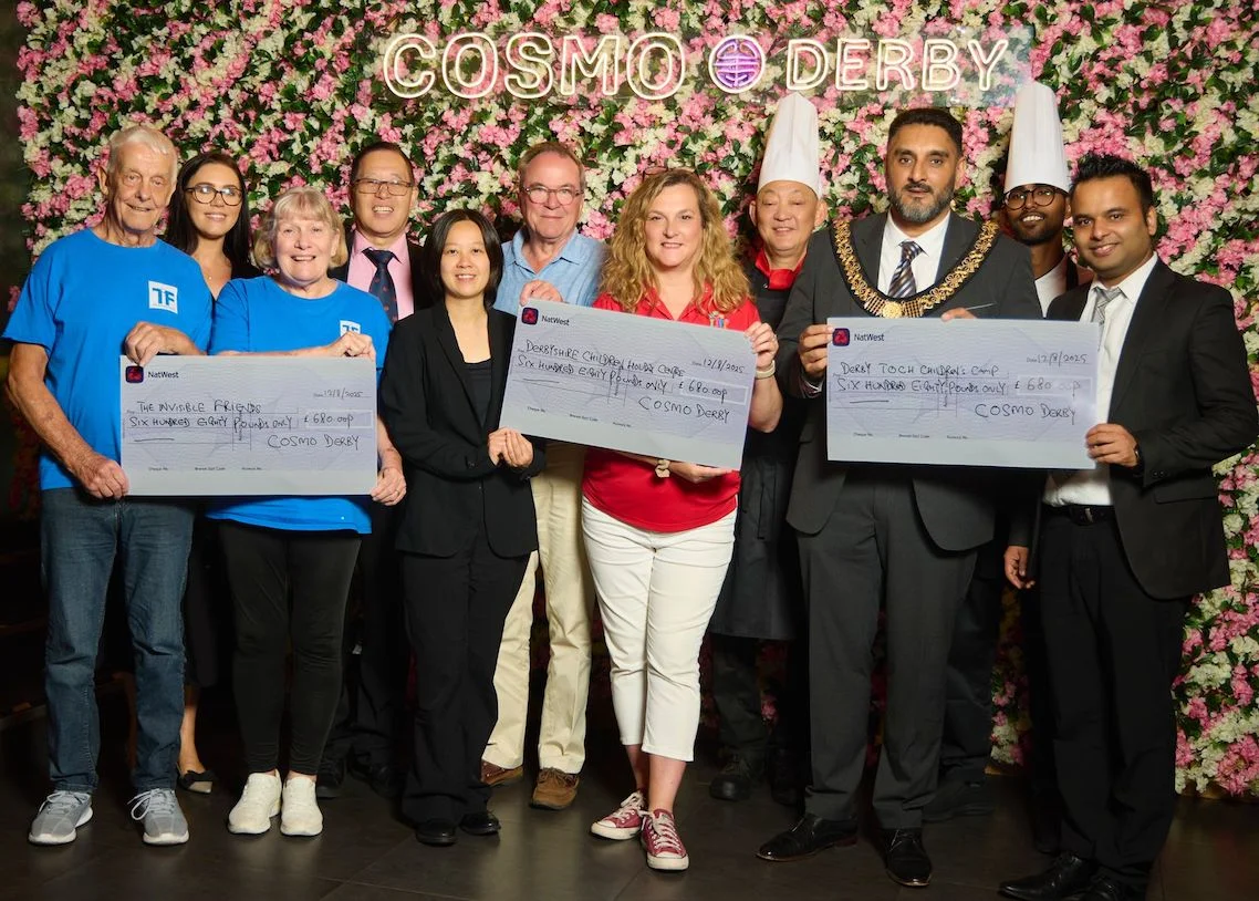 COSMO Derby staff with representatives from three local charities as they receive donation cheques.